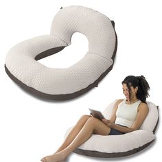 a woman sitting on top of a white pillow next to an inflatable chair