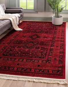 a living room with a couch and rug on the floor