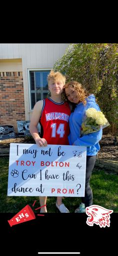 two people standing in front of a sign that says i may not be troy bottom and can i have this dance at prom?