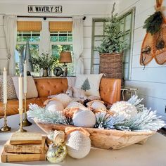 a living room filled with lots of furniture and christmas decorations on top of a table