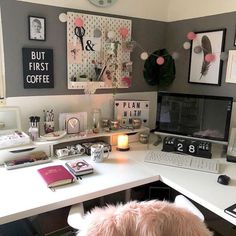 a white desk topped with a laptop computer and a pink dog sitting next to it