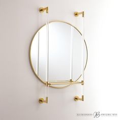 Well, hello gorgeous! Finding a home for this mirror and the coordinating acrylic rod with metal and glass shelf will be effortless. The brass finish on this wall mirror and functional shelf will style nicely in your city apartment, modern farmhouse, or your mountain getaway. Toss your favorite lipstick or keys on the adjustable shelf knowing that you can have it all. Dimensions Overall 30"W x 41.5"H x 7"D (35 lbs) Mirror 0.75"D x 30"Dia. Shelf Dims 16.75"L x 6"W x 0.5"H  Hangs by a 21" metal wa Functional Shelf, Shelf Dimensions, Acrylic Rod, Apartment Modern, Mountain Getaway, Mirror Acrylic, Mirror With Shelf, Glass Shelf, Global Views