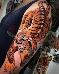 a man with a tiger tattoo on his arm