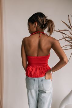 Turn up the heat with the Georgia Halter Top, a striking piece in vibrant bright red. This top features a gathered ruched bodice, creating a flattering and dynamic silhouette. The drawstring neck tie adds a playful touch, allowing you to adjust the fit for a custom look. Perfect for making a bold statement, the Georgia Halter Top pairs effortlessly with jeans, skirts, or shorts, making it a versatile addition to your wardrobe. Embrace the fiery flair and confidence that this top brings to any ou Red Halter Top, Faux Leather Purse, Travel Dress, Ruched Bodice, Jumpsuit Shorts Rompers, Maxi Dresses Casual, Short Jumpsuit, Turn Up, Romper Pants