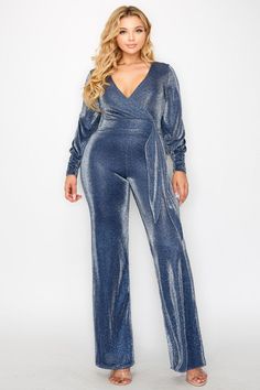 This Plus Size Glitter Fabric Bishop Sleeve Belted Jumpsuit exudes exclusivity and sophistication. Crafted from a high-quality, glitter fabric, this jumpsuit is tailored with bishop sleeves and an adjustable belt to flatter your shape. Perfect for a night out that will have you standing out from the crowd. -GLITTER FABRIC -V NECKLINE -BISHOP SLEEVE -BELTED (SASH) -WIDE LEG -STRETCH -MODEL IS 5'8" AND WEARING A 1X Fabric Contents POLYESTER 95% / SPANDEX 5% Metallic Fitted Long Sleeve Jumpsuits And Rompers, Metallic Long Sleeve Fitted Jumpsuit, Metallic Long Sleeve Jumpsuits For Night Out, Metallic Long Sleeve Jumpsuits And Rompers For Night Out, Metallic Long Sleeve Jumpsuits And Rompers For Party, Glamorous Long Sleeve Jumpsuits And Rompers For Winter, Glamorous Long Sleeve Winter Jumpsuit, Glamorous Evening Jumpsuits For Fall, Glamorous Metallic Shimmer Jumpsuits And Rompers