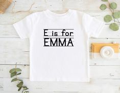 a white t - shirt with the words e is for emma printed on it