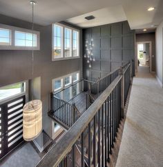 a large open floor plan with stairs and windows