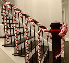 some candy canes are tied to the banister