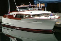 a white and red boat docked at a dock