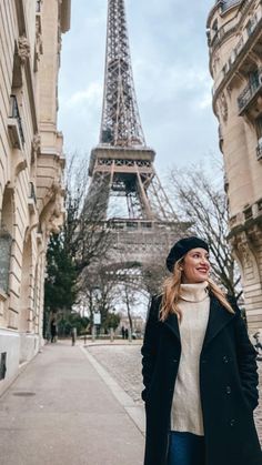 a woman standing in front of the eiffel tower