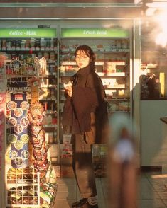 a woman standing in front of a grocery store