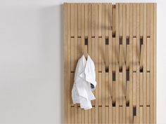 a white shirt hanging on a wooden wall