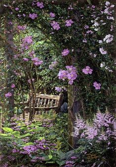 the bench is surrounded by purple flowers and greenery