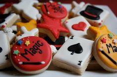 decorated cookies are arranged on a plate with the words magic and magician written on them