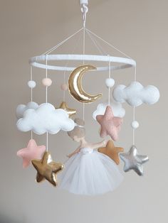 a mobile with stars, moon and clouds hanging from it