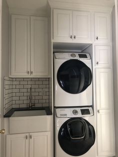 a washer and dryer in a white kitchen