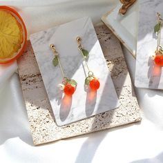 🍊Our vibrant orange dangle earrings are designed to brighten any ensemble with a burst of color. Each earring showcases a translucent lampwork glass orange bead adorned with cute tiny green leaves and a cute white flower. 🍊The full length of the earring is roughly 2.1 inches (52-55MM) from the top to the bottom. 🍊Matching necklace available: https://www.etsy.com/listing/1559883556 ** All the orders will be shipped to the shipping address supplied through your Etsy Order, please check the address in your profile if it is correct before placing your order. ** All jewelry is made to order and may vary slightly from the photograph. ** Please note color may vary on different monitors, If you have any question just send us a message and we will be glad to help you. Orange Drop Earrings For Gift, Orange Dangle Flower Earrings Gift, Orange Dangle Flower Earrings For Gift, Apricot Drop Earrings For Gifts, Orange Dangle Earrings For Gift, Orange Drop Earrings For A Gift, Citrus Earrings, Earrings Food, Fruit Orange