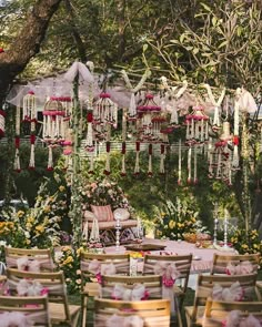 an outdoor wedding setup with chairs and flowers