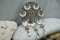 This is the perfect option for those who like cool, unique jewelry, and the luxury, shine of sterling. Vintage Norwegian J 830 Silver Pin Brooch. Composed of filigree circle and 7 cascade of silver filigree with spoons which manages to catch & reflect light beautifully (also reflect negativity & evil) with a simple movement. Is Norway's traditional silver jewelry. Its dangling spoons once were thought to reflect evil. Away from the wearer, protecting one from trolls and other dangers, es Silver Bohemian Brooch Jewelry, Silver Bohemian Jewelry Brooch, Handmade Silver Pendant Brooch, Handmade Silver Pendant Brooches, Unique Silver Pendant Brooch, Handmade Ornate Sterling Silver Brooches, Handmade Silver Bohemian Brooch, Traditional Handmade Sterling Silver Brooches, Ornate Handmade Pendant Brooches