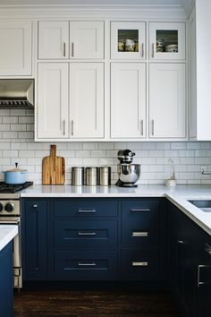 a kitchen with white cabinets and blue counter tops is seen in this image from the front view