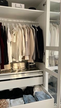 an organized closet with clothes and other items