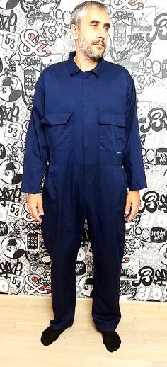 "One Piece blue Coveralls vintage blue Jumpsuit mens Overalls zip up mens Coveralls utility workwear mechanic uniform XXL height of the men in the photo - 187 cm 35% - cotton; 65% - polyester Please refer to photos for details of condition. Condition: very good vintage Measurements : Length: 161 cm/63.38\" Shoulders: 55 cm/21.65\" Sleeve : 56 cm/22.05\" Bust: 142 cm/ 55.91\" Waist:122 cm/ 48.03\" Hips: 132 cm/51.96\" Rise: 90 cm/ 35.43\" Inseam 78 cm/30.71\" Tag size : XXL note The color on the Blue Workwear Shortalls With Pockets, Blue Cotton Utility Shortalls, Blue Utility Jumpsuits And Rompers With Side Pockets, Blue Utility Jumpsuits With Side Pockets, Navy Overalls With Pockets, Blue Overalls With Side Pockets For Work, Long Sleeve Blue Cotton Overalls, Blue Long Sleeve Utility Overalls, Mechanic Uniform