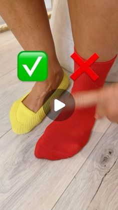 a person wearing red socks and yellow socks with green tickes on their feet while pointing to the floor