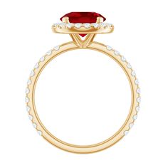 a yellow gold ring with a red stone and white diamonds on the band, set in 18k yellow gold