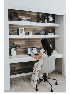 a woman sitting at a desk using a laptop computer