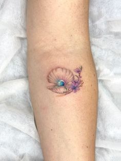 a woman's leg with a flower tattoo on the left side of her calf