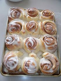 a pan filled with cinnamon rolls sitting on top of a counter