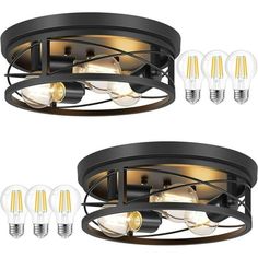 two black ceiling lights with bulbs on each side and one light bulb in the middle