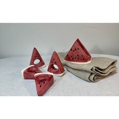 Pop Art Perfection! Juicy watermelon slice ceramic  napkin rings will add a touch of  Americana style to your table or picnic blanket!  So will the matching napkin holder!   Set of 5 includes:  DIMENSIONS  Napkin rings (4) 3”w 1”d 4”h  Napkin holder (1) 5”w 2.5”d 4.5”h Cute Napkin Holder, Clay Napkin Holder, Watermelon Ceramic, Sliced Watermelon, Ceramic Napkin Holder, Ceramic Napkin Rings, Juicy Watermelon, Beginner Pottery, Watermelon Slice