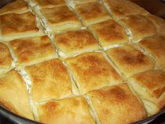 a pan filled with bread sitting on top of a stove