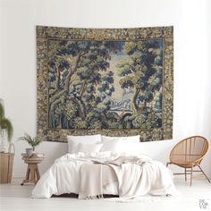 a tapestry hanging on the wall above a bed