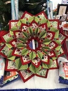 a christmas wreath sitting on top of a table next to cards and other holiday decorations