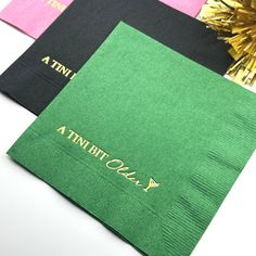 four napkins with gold foil on them and the words, a tunbit one