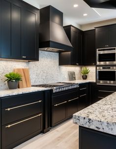 a kitchen with black cabinets and white marble counter tops is pictured in this image from the front view