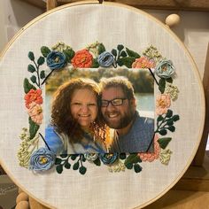 an embroidered photo frame with flowers on it