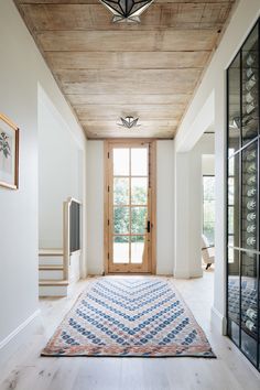 a room with a door and a rug on the floor