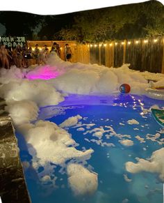 a pool filled with foam and people standing around it