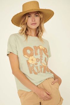 Mineral-washed graphic t-shirt. Vintage-style "One of a Kind" text print with flower graphics. Crew neckline. Short drop-shoulder sleeves. Relaxed fit. 100% Cotton. Imported top designed and printed in LA. Model wears size S. Muted Sage, Flower Graphics, Text Print, Vintage Canvas, Iron Decor, Charcoal Color, Shoulder Sleeve, Drop Shoulder, Crew Neckline