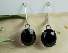 These are a stunning pair of Black Tourmaline from Tanzania set in Sterling Silver! These gems have the look, luster, and appeal of Black Diamonds but does not carry the hefty price tags!! They have a great and uniform color with good luster and opaque clarity. These larger sized 11mm x 9mm Oval Black Tourmaline weigh 9.20cts and will go great with any style or occasion along with practically any pendant located in our Gemstone Pendant section of our store! Please feel free to check out our selection!! Tourmaline Earrings, Black Diamonds, Price Tags, Black Tourmaline, Tanzania, Black Diamond, Gemstone Pendant, Tourmaline, Favorite Jewelry