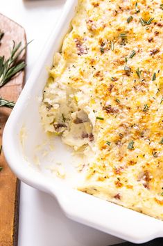 a casserole dish with cheese and herbs