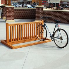 a bicycle parked next to a wooden bench