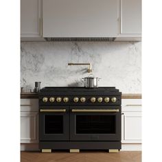 a black stove top oven sitting inside of a kitchen next to a white countertop