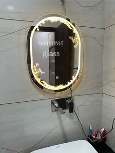 a bathroom with a sink, mirror and hair dryer on the wall next to it