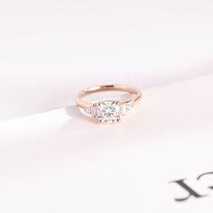 a diamond ring sitting on top of a piece of paper