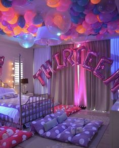 a bedroom decorated with balloons and bedding