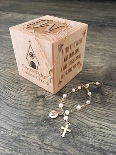 a rosary and wooden box on a table